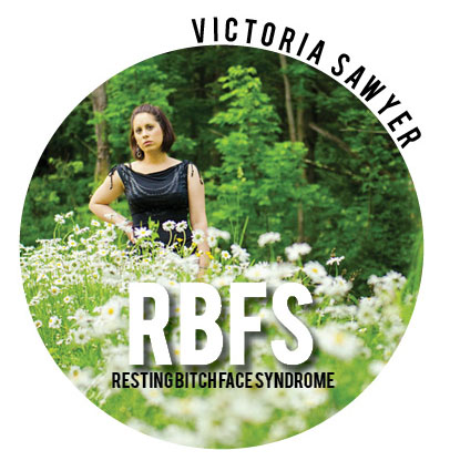 Photo of Victoria Sawyer in a field of flowers, looking...well...bitchy